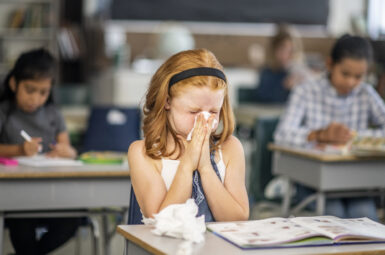 Child Sneezing in a classroom